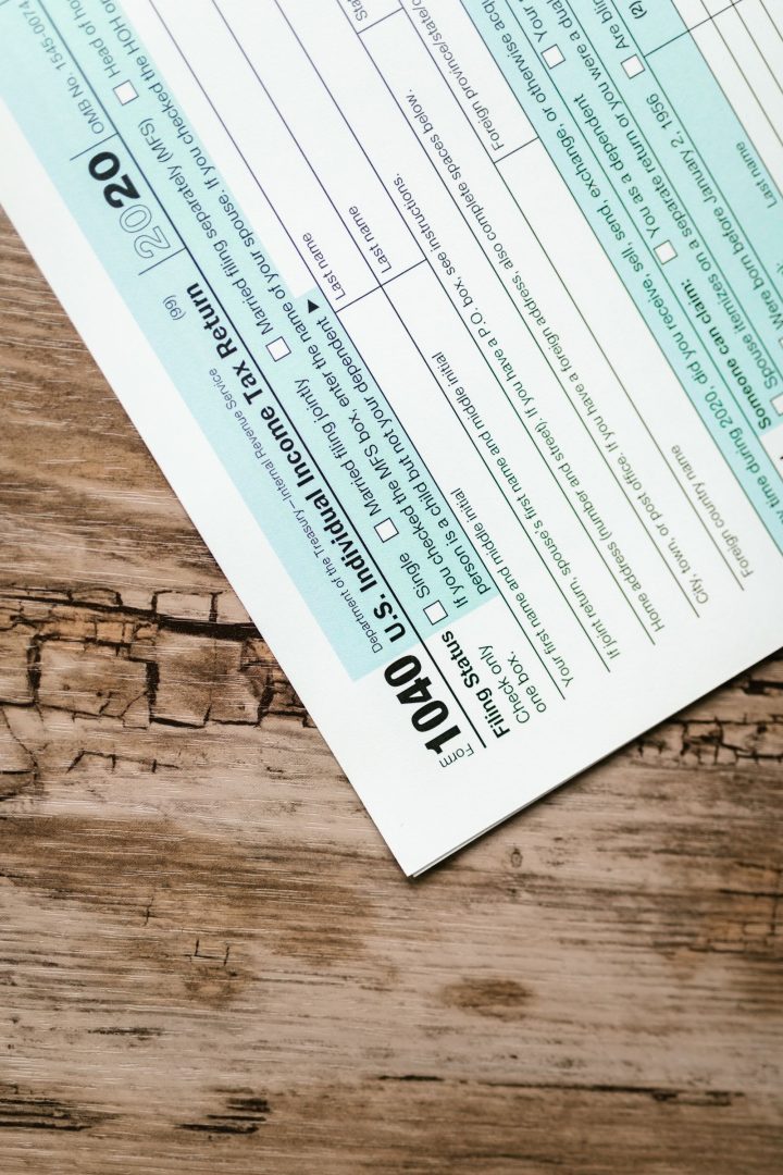 IRS Form 1040 individual income tax return on a wooden desk
